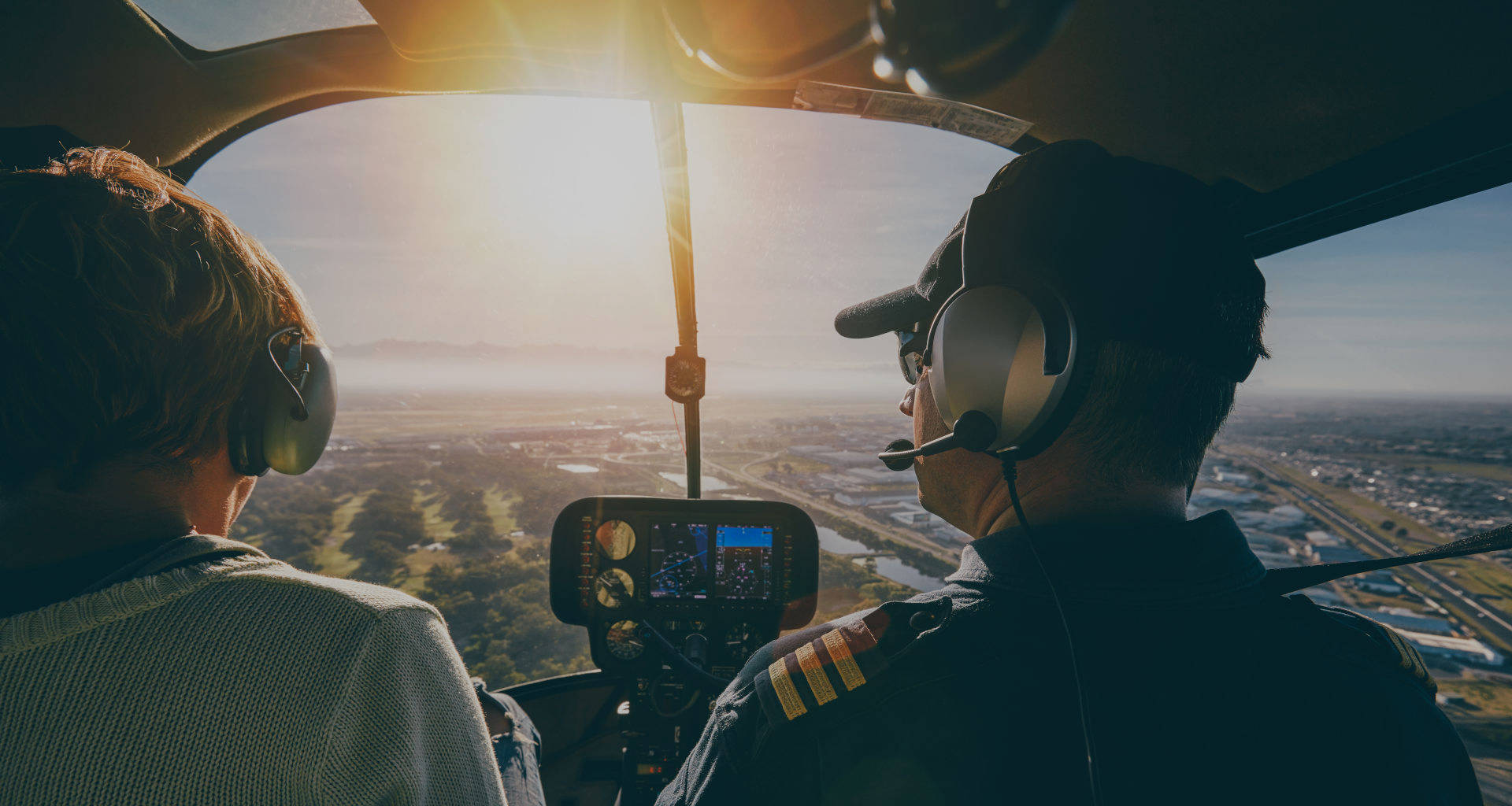 Two people in the cockpit of a helicopter